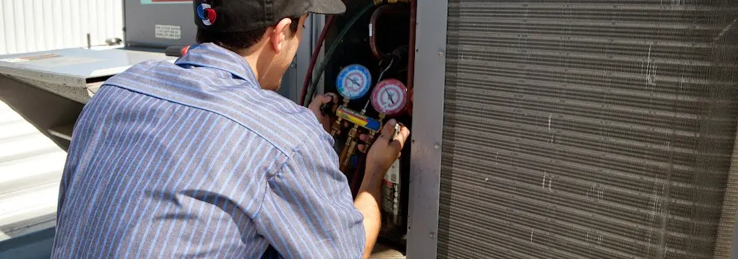 HVAC technician servicing a condenser unit in Summerlin South