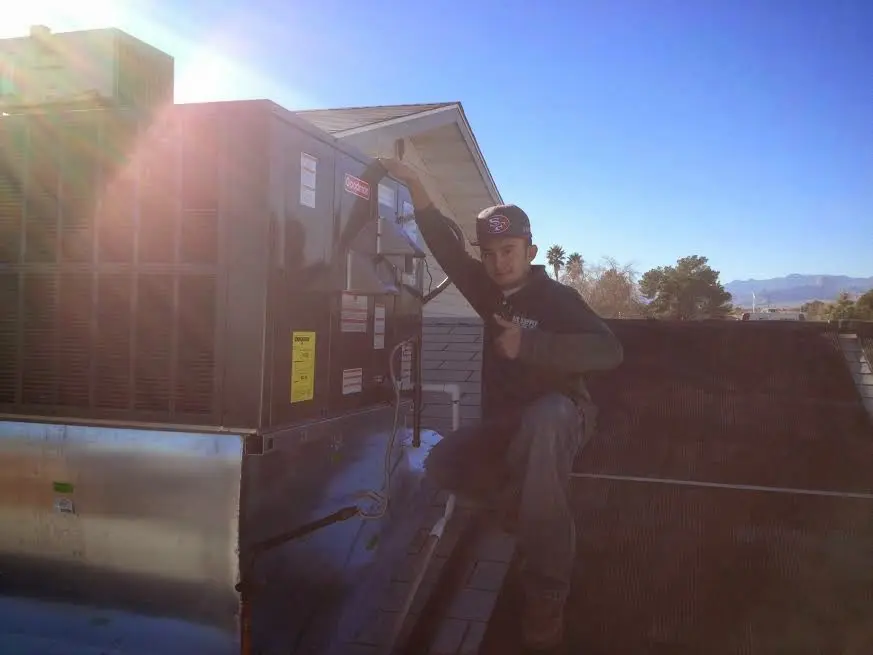 HVAC technician performing AC Tune-Up on a rooftop unit in Summerlin South